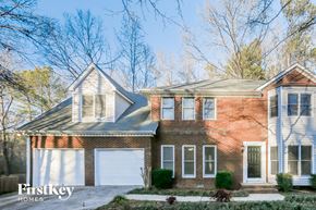 Powder Springs house for rent - a brick house with a white garage door
