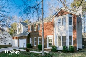 Powder Springs house for rent - a brick house with white siding and a white garage