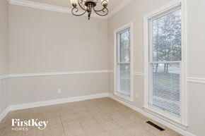 Powder Springs house for rent - a dining room with two windows and a tile floor and a chandelier