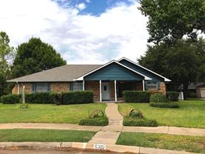 Garland house for rent - a house with a yard and a sidewalk in front of it
