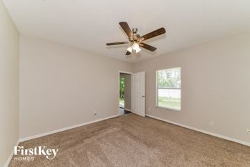 North Port house for rent - a living room with carpet and a ceiling fan