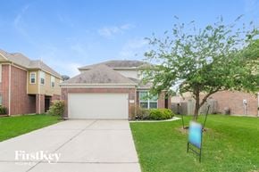 Baytown house for rent - a house with a driveway and a garage door in front of it