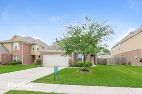Baytown house for rent - a home with a lawn and a tree in front of it
