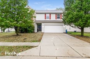 Indianapolis house for rent - A house with a red and white garage door is for sale.