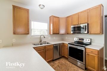 Indianapolis house for rent - A kitchen with wooden cabinets and stainless steel appliances.