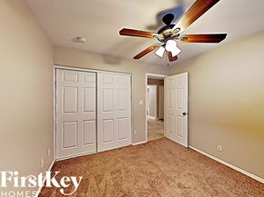 Glendale house for rent - the master bedroom has a ceiling fan and a beige carpet