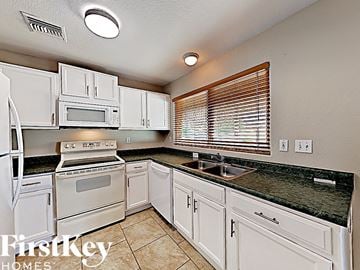 Glendale house for rent - a white kitchen with white appliances and white cabinets