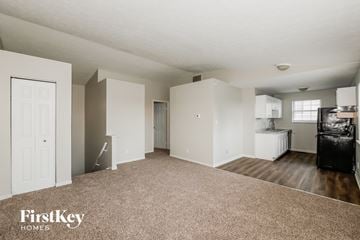 Indianapolis house for rent - A spacious living room with a couch and a television.