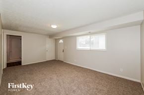 Indianapolis house for rent - A spacious room with a carpeted floor and a window.