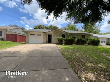 Garland house for rent - a house with a driveway and a garage door