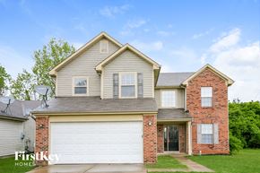 Indianapolis house for rent - a home with a white garage door and a brick house