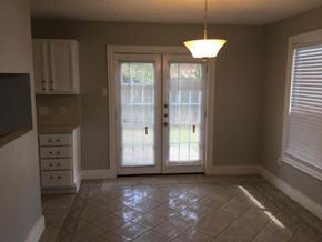 Mesquite house for rent - an empty dining room doors and a tile floor