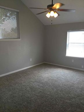 Mesquite house for rent - a bedroom with a ceiling fan and a window