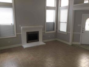 Mesquite house for rent - a living room with a fireplace and a tiled floor