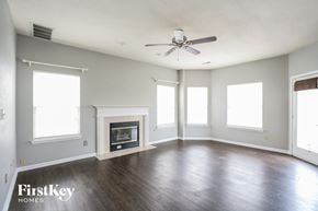 Indianapolis house for rent - an empty living room with a ceiling fan and a fireplace
