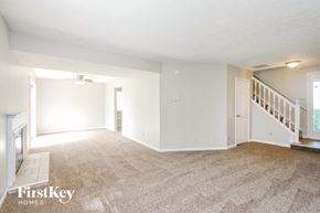 Indianapolis house for rent - A spacious room with a staircase leading to the second floor.