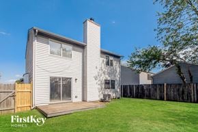 Indianapolis house for rent - A house with a grey exterior and a wooden fence.