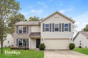 Indianapolis house for rent - a white and brick house with black shutters and a driveway
