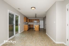 Indianapolis house for rent - a kitchen with white appliances and wooden cabinets and tiled floors