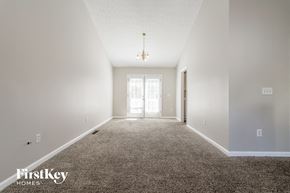 Sugar Hill house for rent - A carpeted hallway with a light on the ceiling and a door at the end.