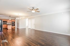 Concord house for rent - an empty living room with a ceiling fan and wood flooring