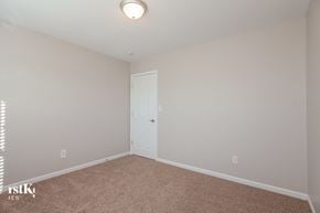 Concord house for rent - a bedroom with white walls and a white door and carpet