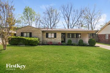 Memphis house for rent - a brick house with black shutters and a green lawn