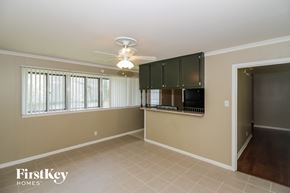 Memphis house for rent - a living room with a kitchen and a ceiling fan
