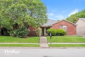 Arlington house for rent - a brick house with a yard and a parking meter