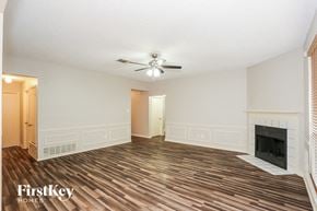 Arlington house for rent - a living room with a fireplace and a ceiling fan