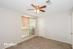 Arlington house for rent - a bedroom with a ceiling fan and a window