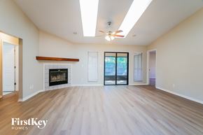 St. Augustine house for rent - A spacious living room with a fireplace and sliding glass doors.