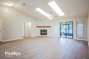 St. Augustine house for rent - A spacious room with a fireplace and sliding glass doors.