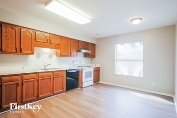 St. Augustine house for rent - A kitchen with wooden cabinets and a dishwasher.