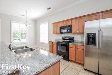 Trussville house for rent - a kitchen with stainless steel appliances and granite counter tops