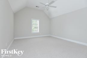 Trussville house for rent - a bedroom with white walls and a ceiling fan