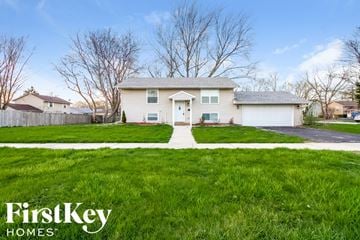 Matteson house for rent - a white house with a lawn in front of it