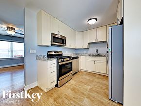 Matteson house for rent - a kitchen with stainless steel appliances and white cabinets