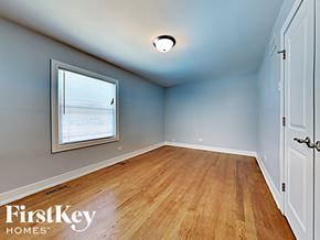 Matteson house for rent - an empty bedroom with wood floors and a window