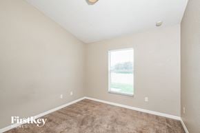 Auburndale house for rent - a bedroom with carpet and a large window
