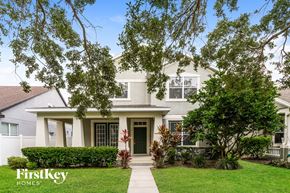 Windermere house for rent - A house with a green lawn and trees in front of it.