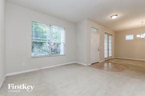 Windermere house for rent - A spacious room with a door and a window.
