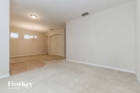 Windermere house for rent - A spacious room with a door and a chandelier.