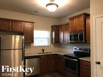 Union City house for rent - full view of a kitchen with stainless steel appliances and wooden cabinets