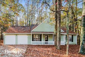 Powder Springs house for rent - a green and white house in the woods
