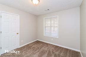 Powder Springs house for rent - a bedroom with carpet and a white door