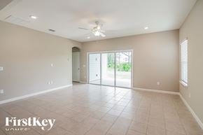 Jacksonville house for rent - A spacious room with a sliding glass door leading to a balcony.