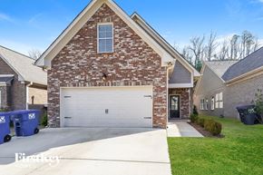 Birmingham house for rent - a home with a white garage door in front of a brick house