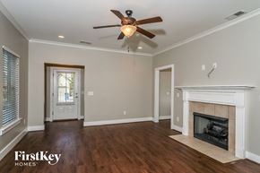 Birmingham house for rent - a living room with a fireplace and a ceiling fan