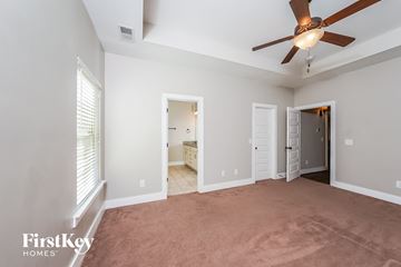 Birmingham house for rent - a living room with a ceiling fan and a carpet